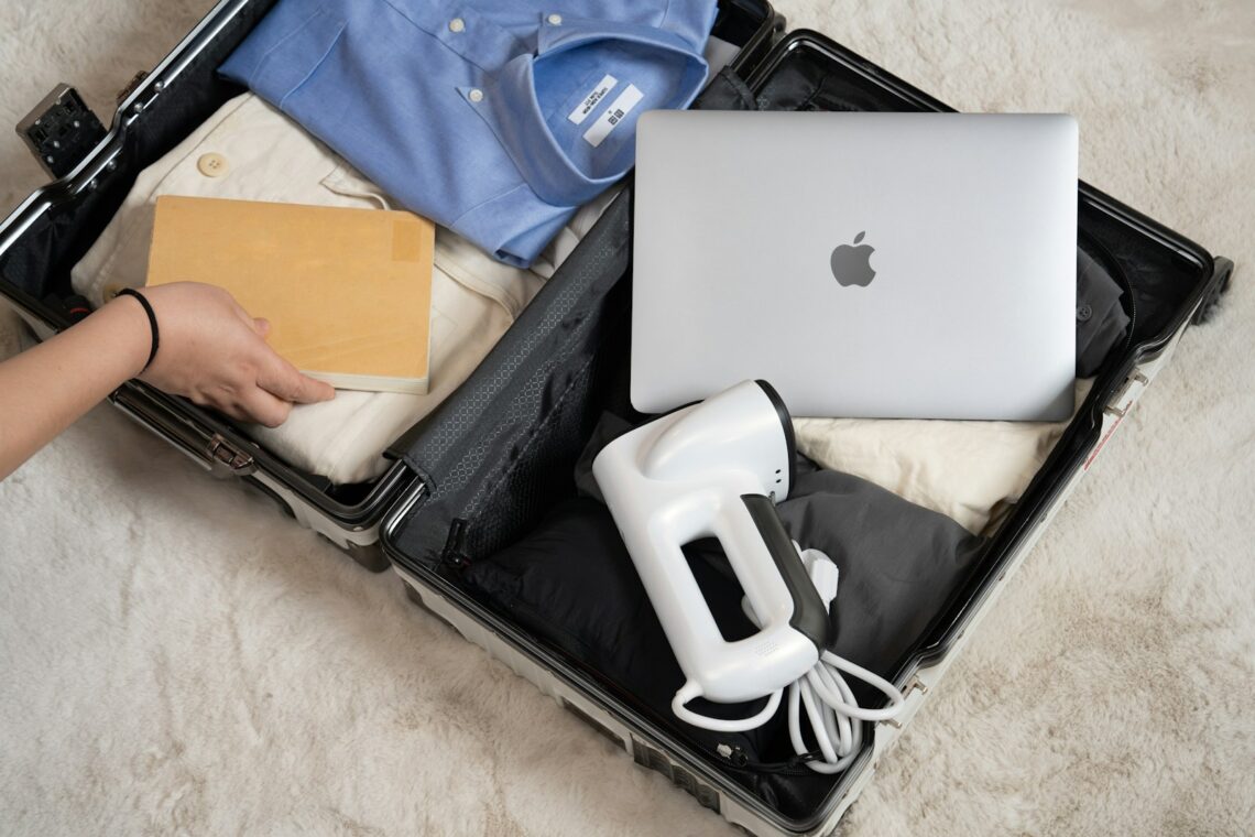 An open suitcase with a laptop and other items