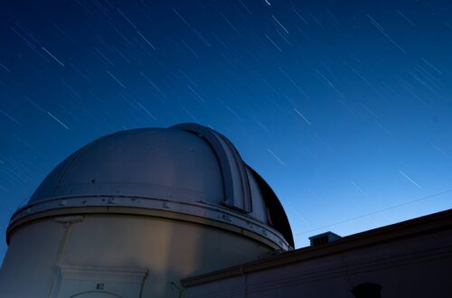 Observatory dome under a starry night sky.